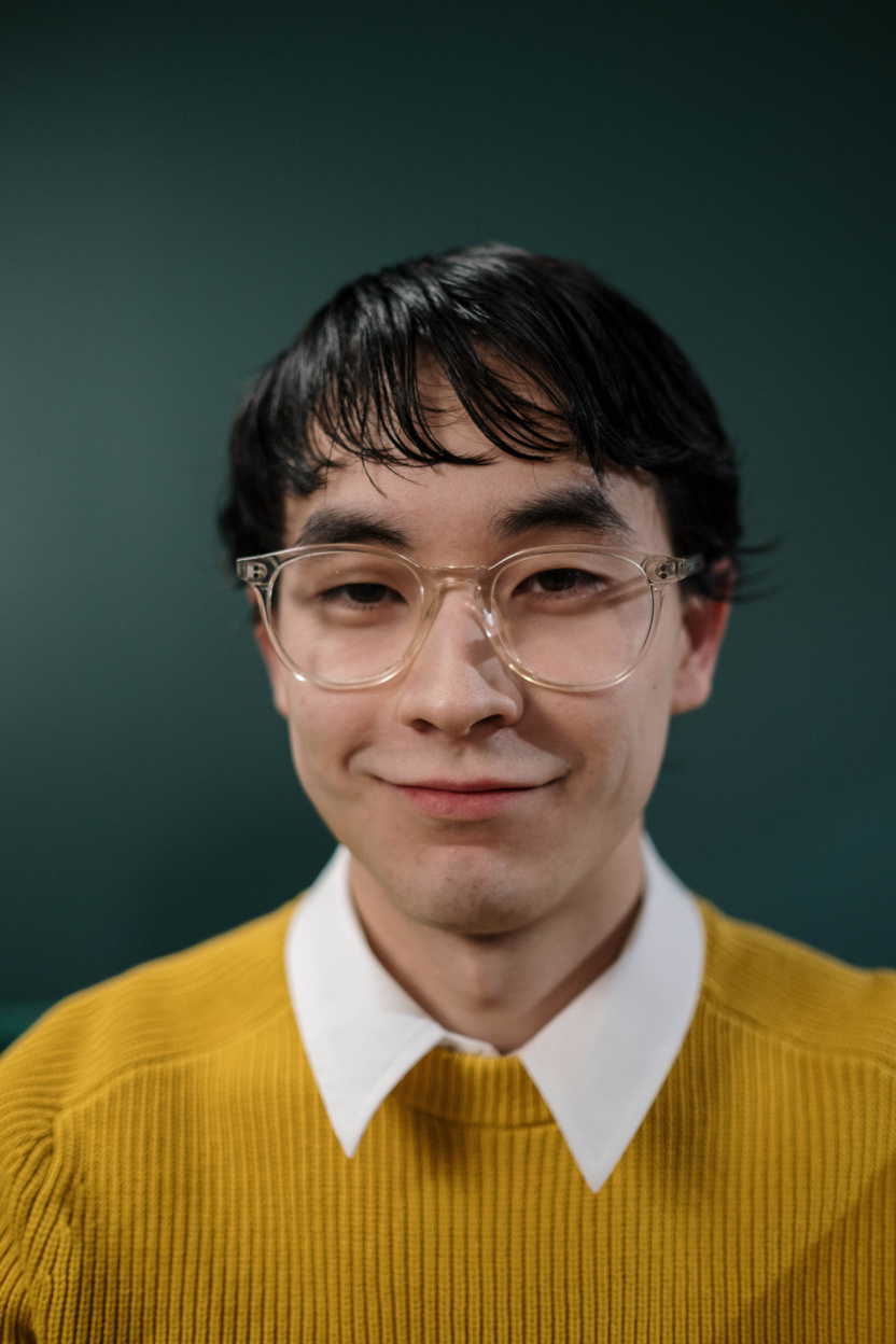 Portrait of a Man in a Mustard Sweater Looking at the Camera